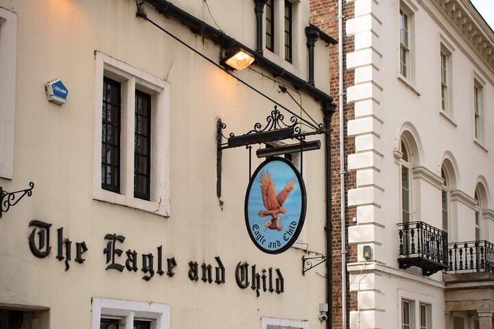 The Eagle and Child pub exterior with hanging sign.