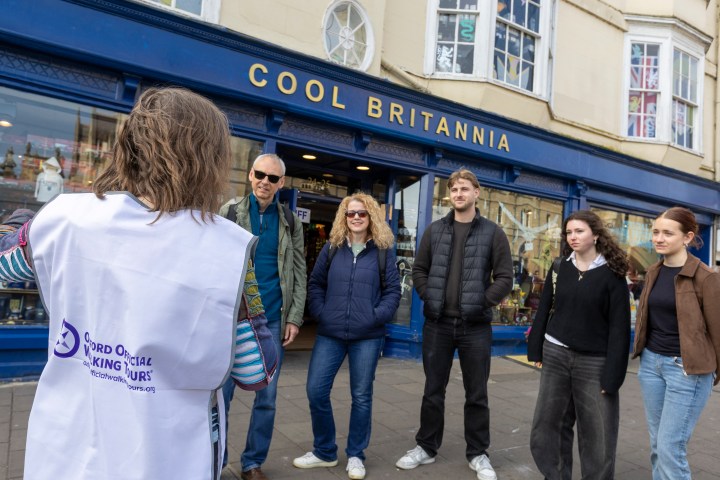 Group of five people outside 'Cool Britannia' store.