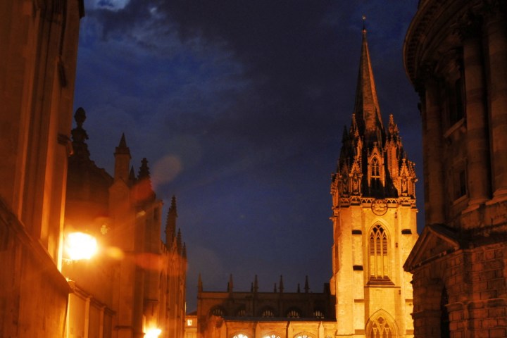 a large clock tower towering over the city at night