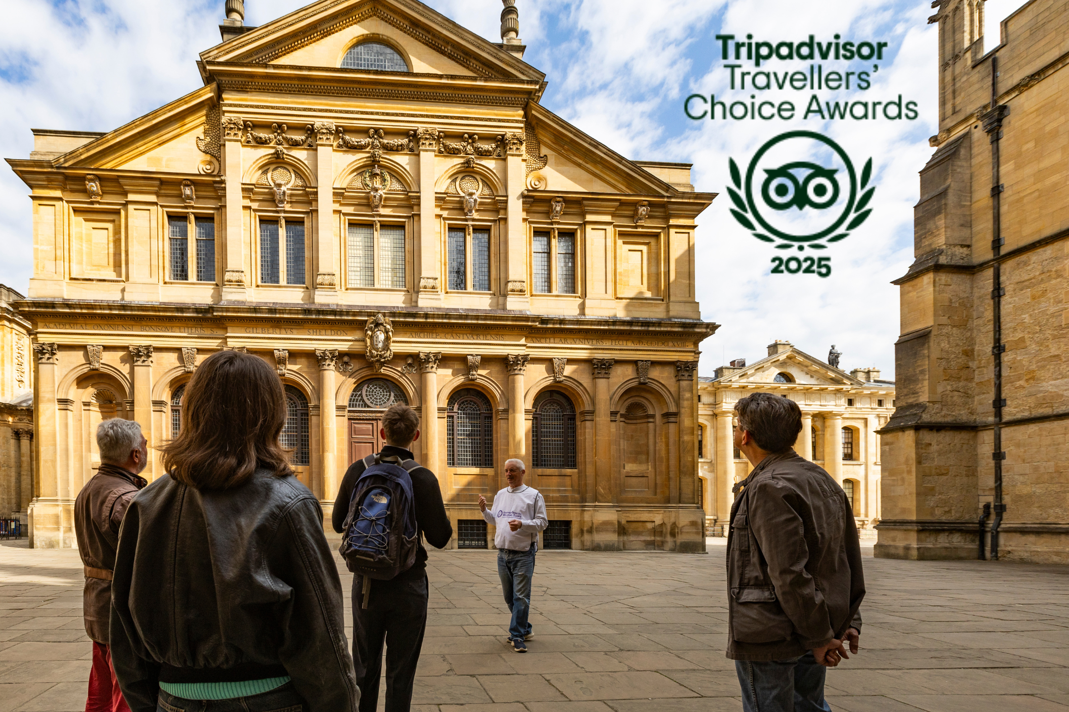 Tour guide speaking to group in front of historic building with Travelers' Choice award logo.