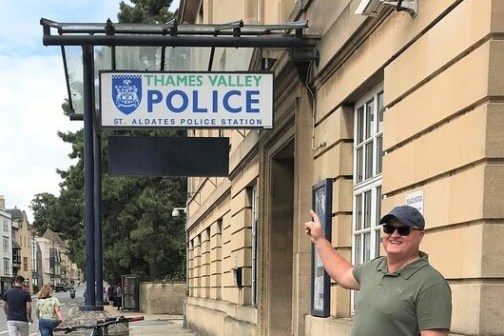 a man standing on a sidewalk