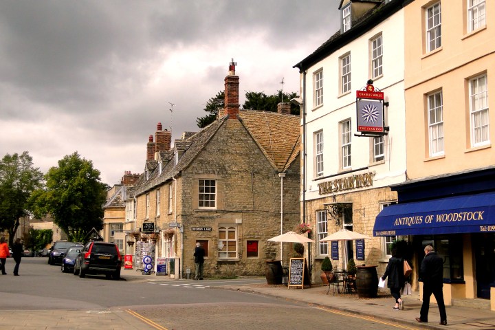 a group of people walking down a street in front of a building