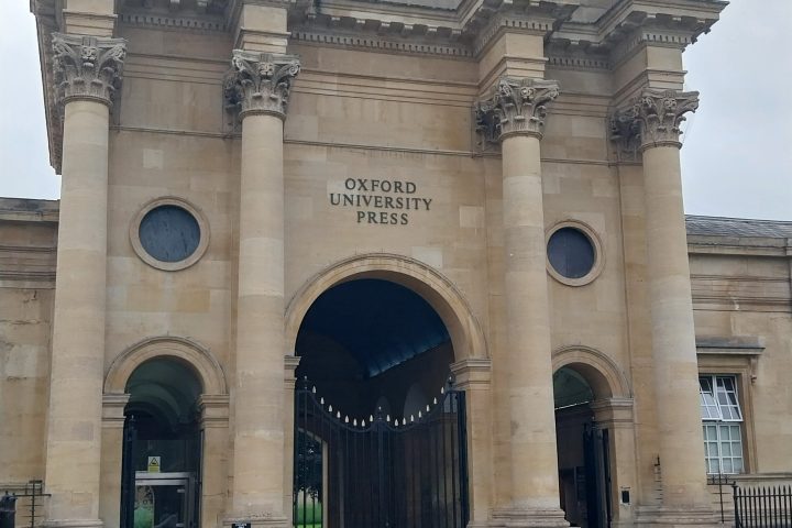 Historic building with columns and Oxford University Press sign.